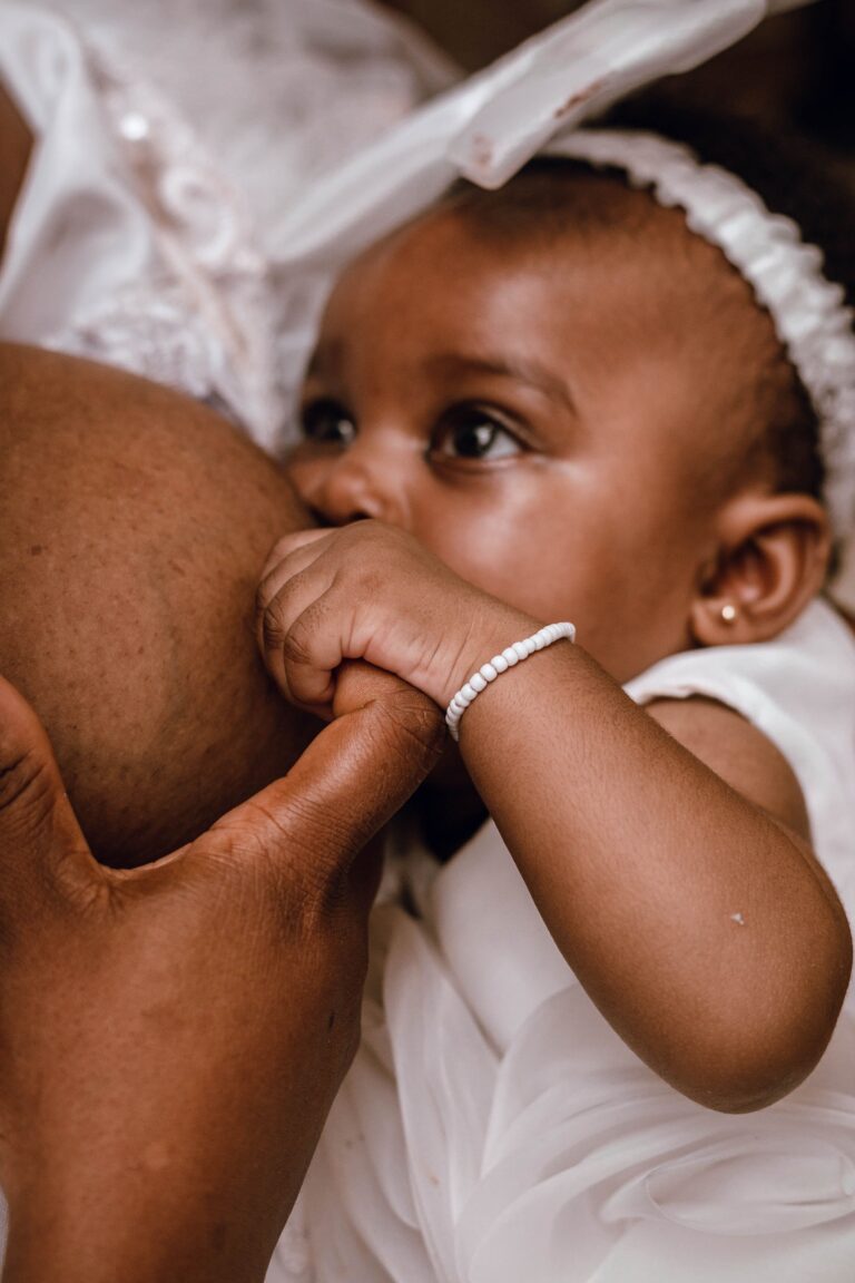 A tender moment of a mother breastfeeding her baby, symbolizing love and connection.